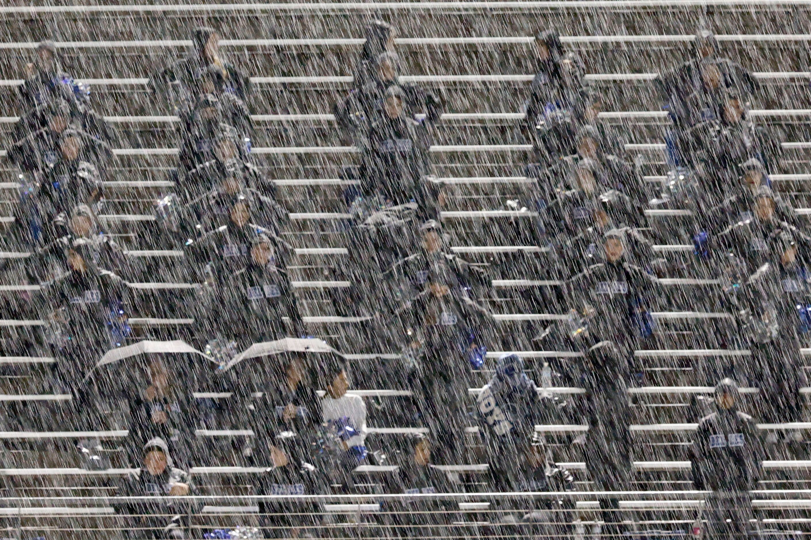 Weatherford’s Blue Belle dance team members perform in the rain during the second half of a...