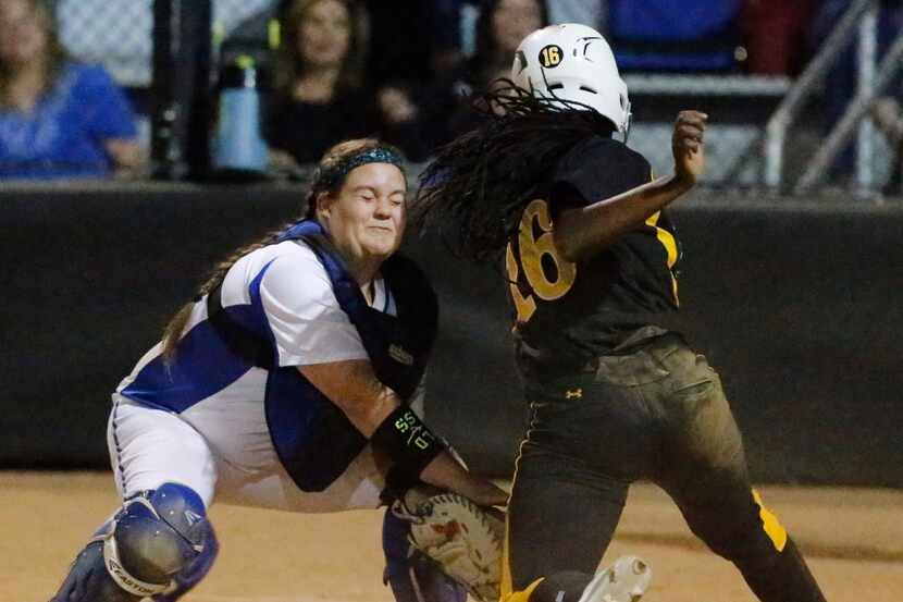 Plano West catcher Tatum Boyd (2) puts the tag on Plano East third baseman Mo Dickerson (16)...