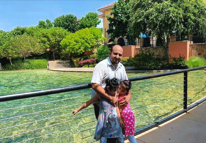 Mahir Ahmad Amiri with his two daughters, Nada and Zianib, at a park in Dallas. It is not...