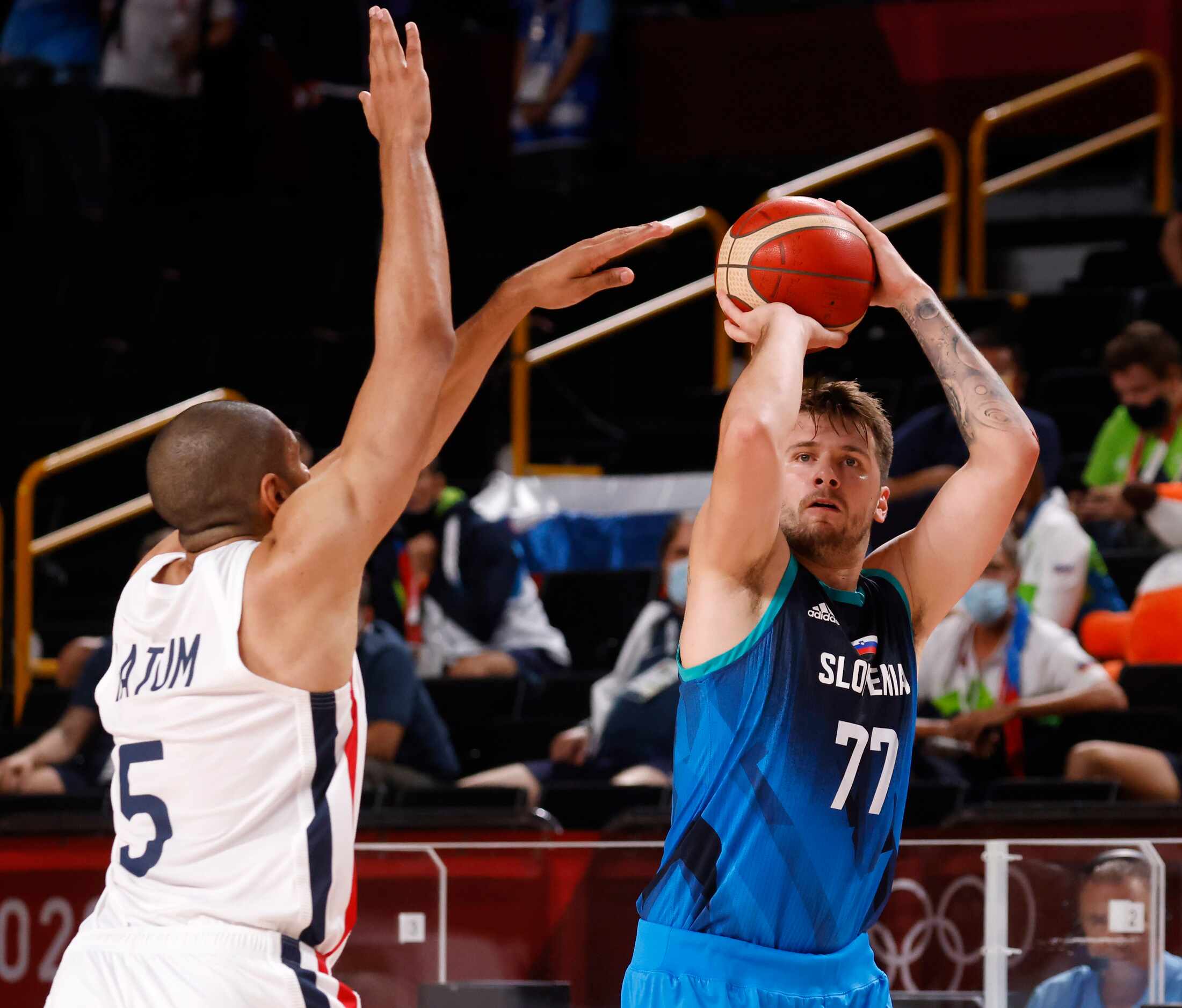 Slovenia’s Luka Doncic (77) shoots a three pointer in front of France’s Nicolas Batum (5)...