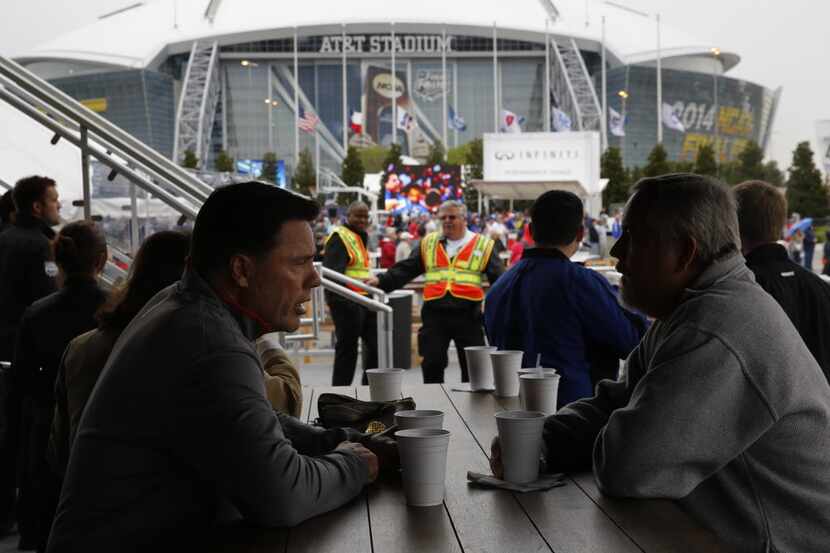 Fans relax in the Tip-Off Tailgate party before the NCAA Final Four at AT&T Stadium in...