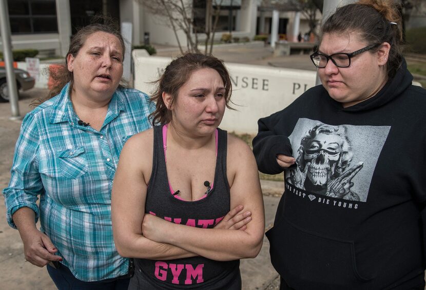 Angel Velazquez, standing center, speaks to local news media about how the U.S. Immigration...