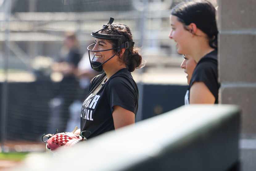 John H. Guyer High School softball player Jenny Robledo, waits by the sideline during a team...