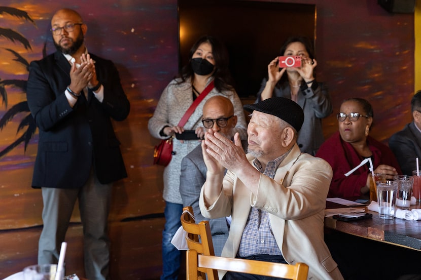 Luncheon attendees applauded during introductions at the event. Charles Park (foreground)...