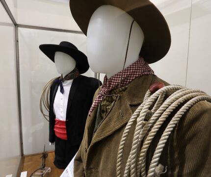 Traditional cowboy clothing on display during the Shared Border exhibit at Fair Park's Hall...