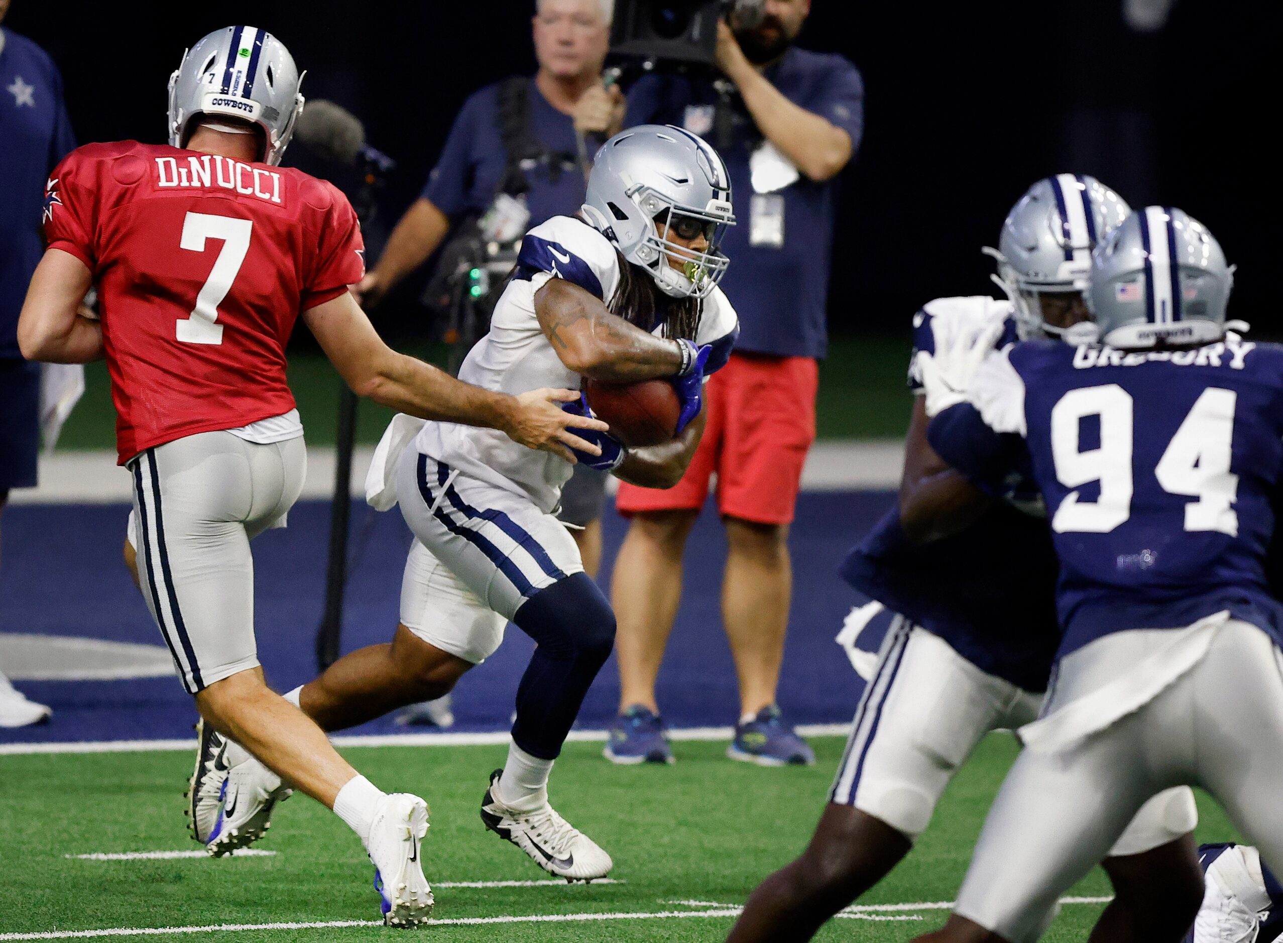 Dallas Cowboys running back JaQuan Hardy (37) takes the handoff from quarterback Ben DiNucci...