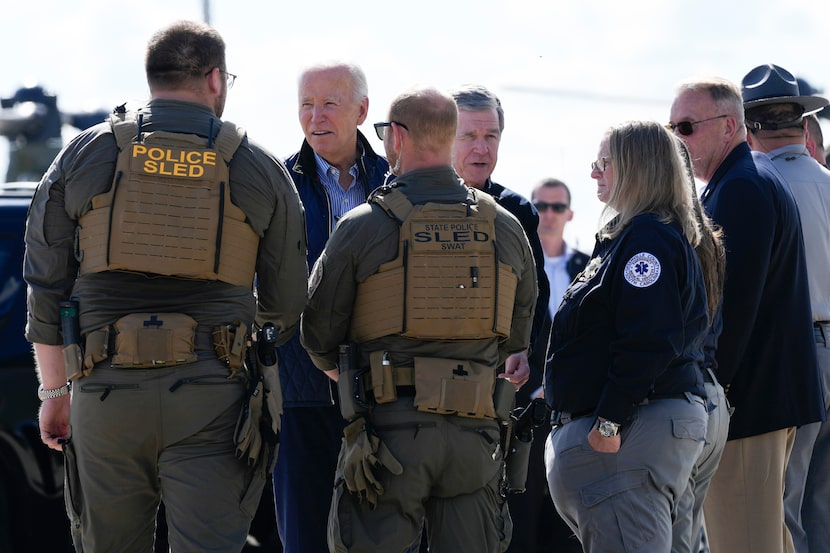 President Joe Biden and Gov. Roy Cooper, D-N.C., greet first responders  at the ariport in...