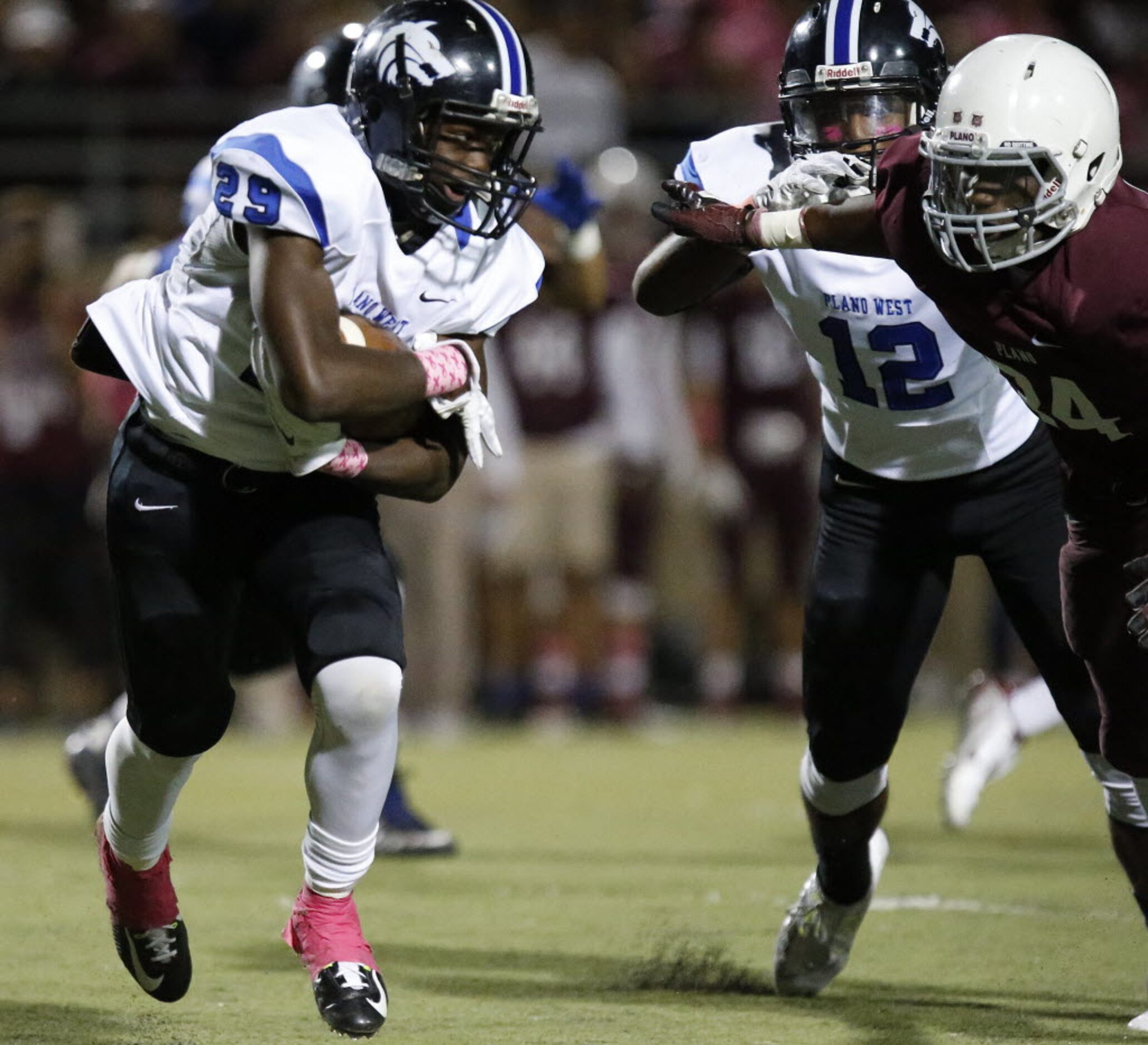 Plano West High School running back Da’Vonte Carline (29) looks for room to run as Plano...