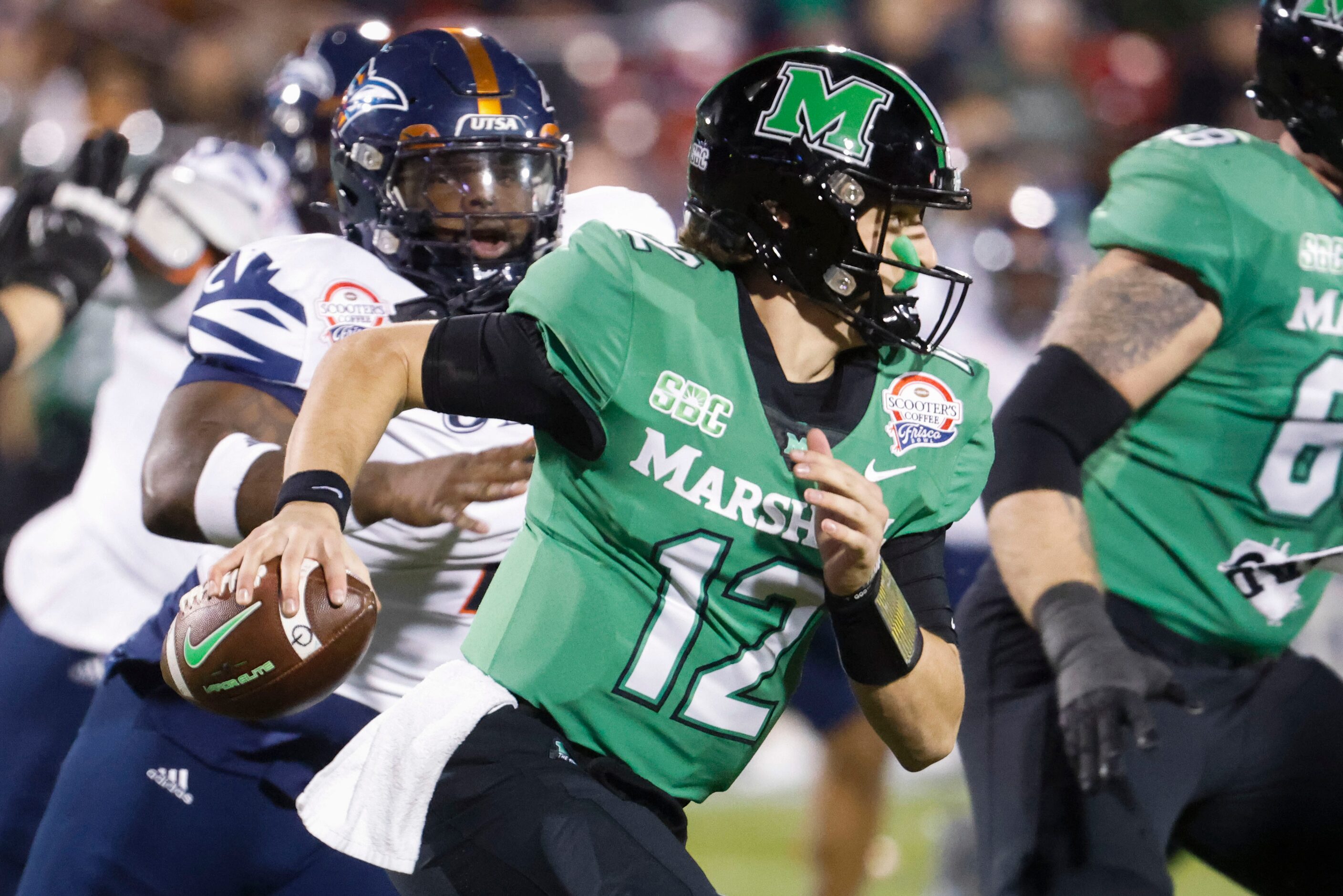 Marshall quarterback Cole Pennington (12) runs with the ball against UTSA during the first...