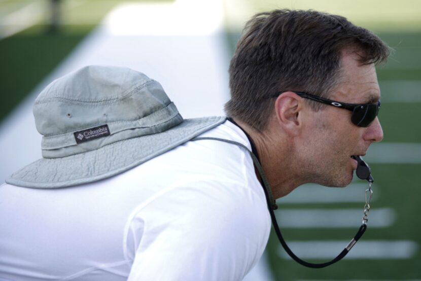 Jeff Jordan, head football coach at Garland High School, runs a football practice at...