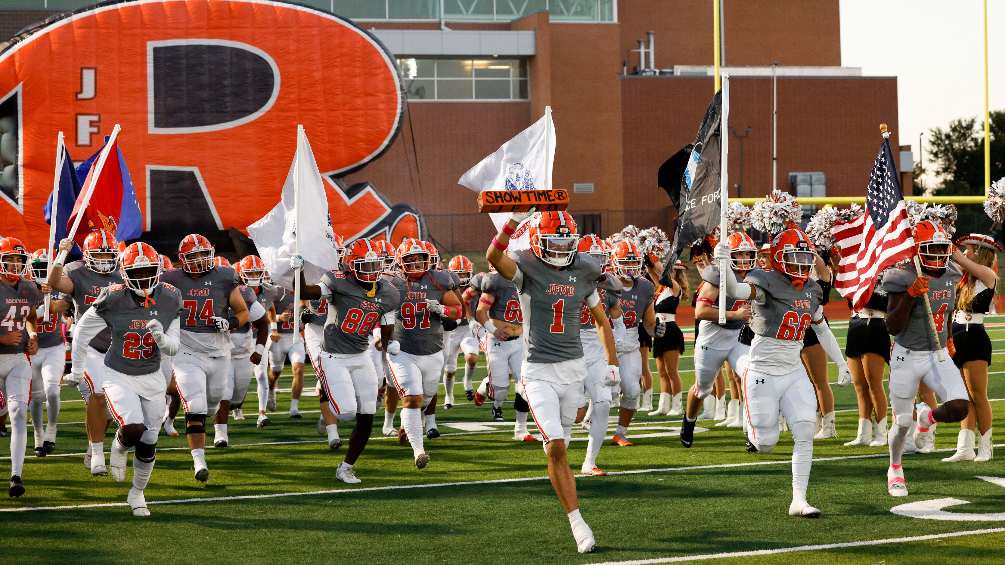 Rockwall wide receiver Kai Helton (1) leads the team onto the field before a District 10-6A...