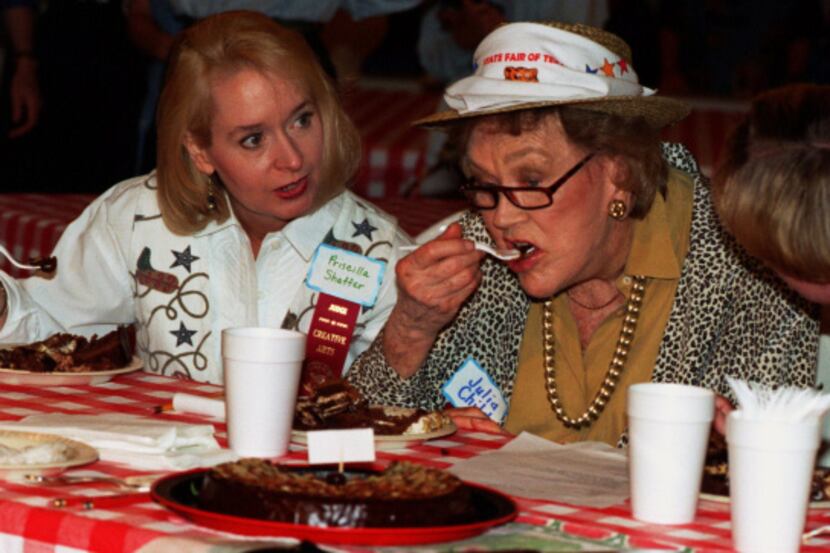Prissy Shaffer (left) and Suzanne Hough (right) watch Julia Child take a bite of chocolate...