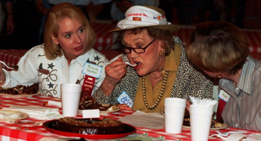 Prissy Shaffer (left) and Suzanne Hough (right) watch Julia Child take a bite of chocolate...
