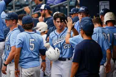 Flower Mound’s Andrew Robinson (2) celebrates in the dugout after scoring during Game 3 of a...