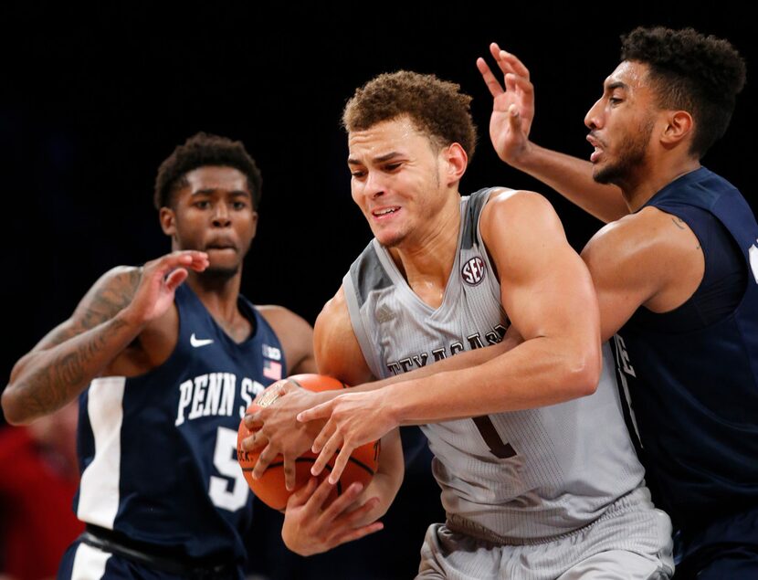 Penn State forward Julian Moore, far right, tries to strip the ball from Texas A&M forward...