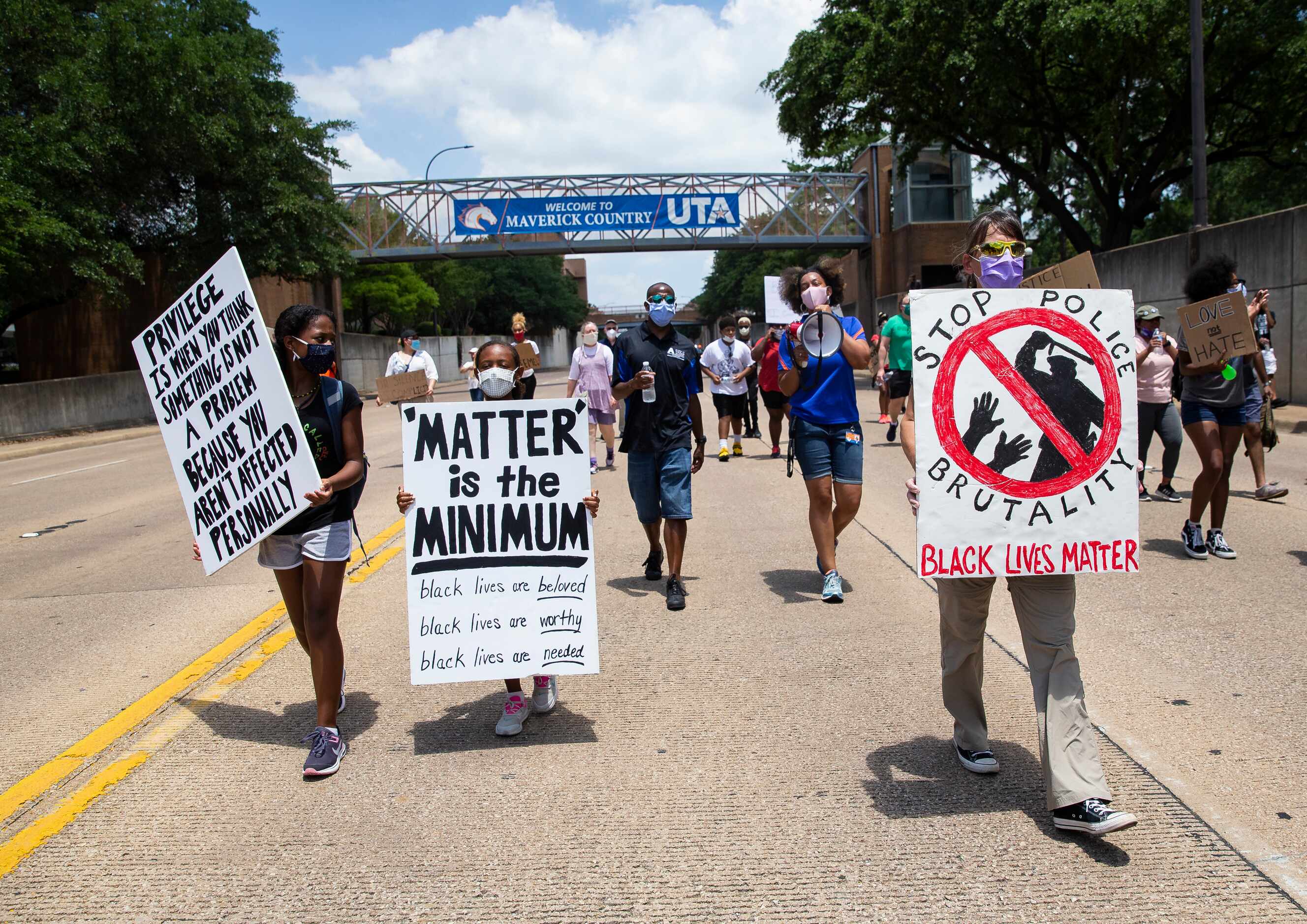 Protestors against police brutality march down S Cooper St as they participate in the UTA...