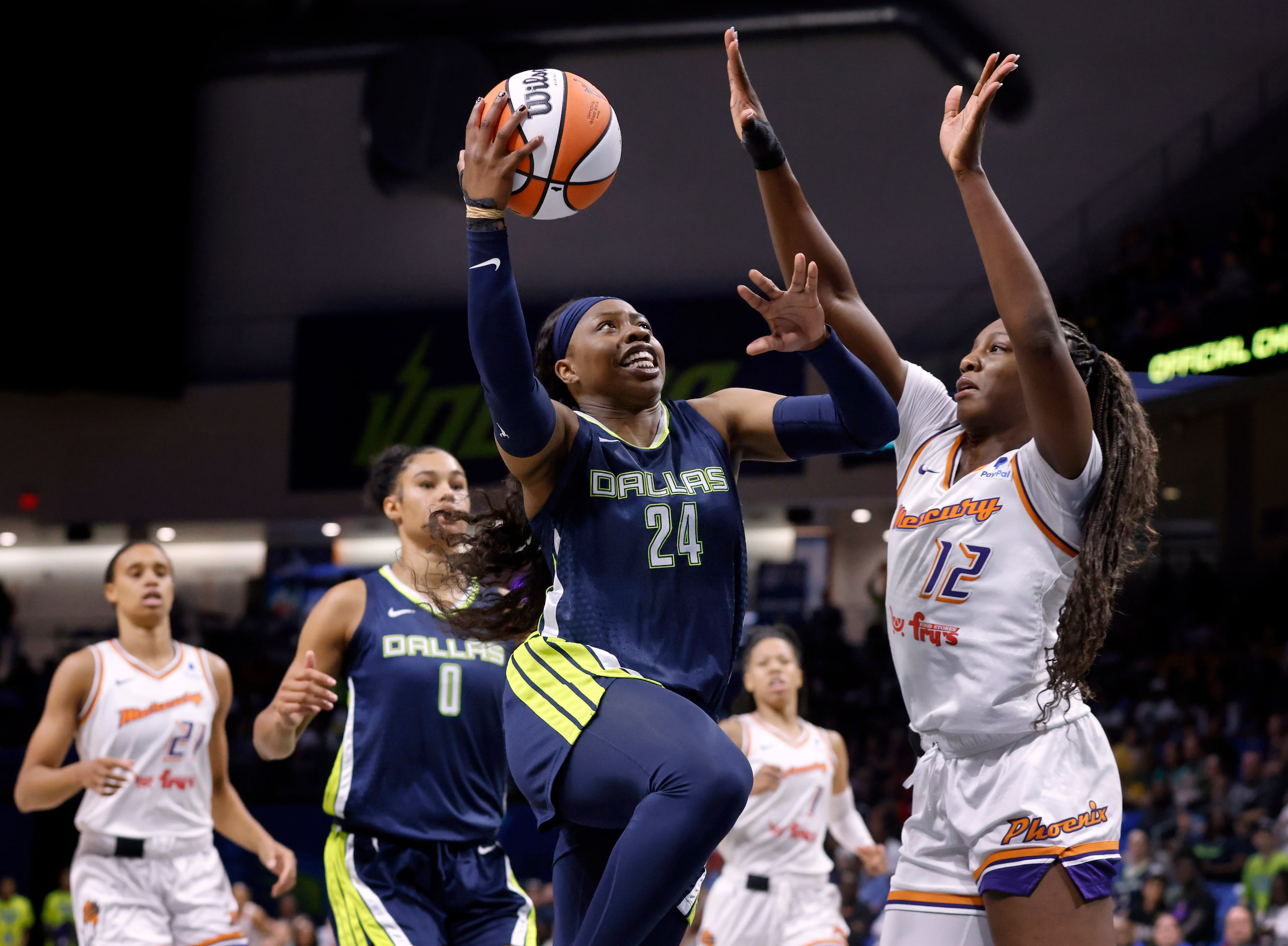 Dallas Wings guard Arike Ogunbowale (24) lays up a first half shot agsinst Phoenix Mercury...