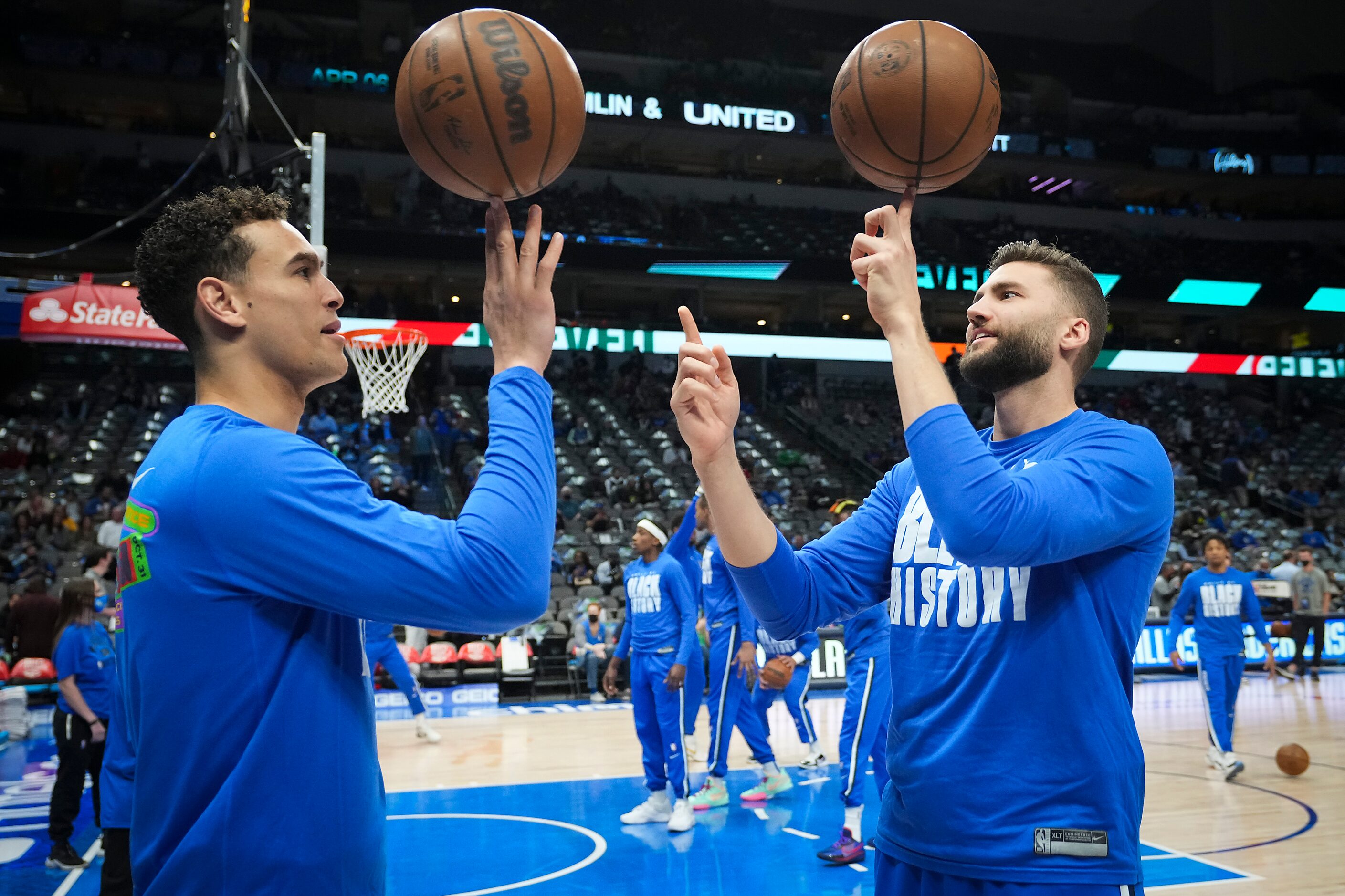 Dallas Mavericks center Dwight Powell (left) and forward Maxi Kleber spin balls on their...