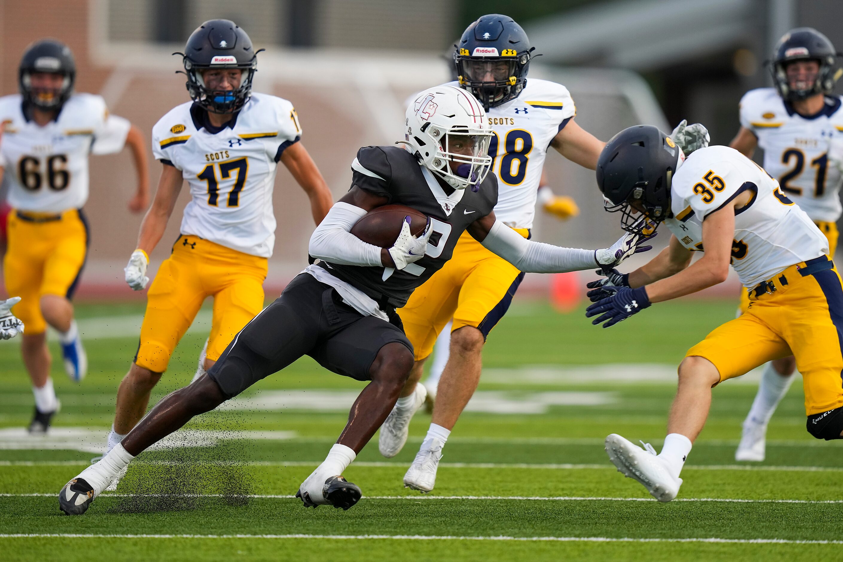 Lewisville defensive back Cameren Jenkins (2) returns a kickoff during the first half of a...