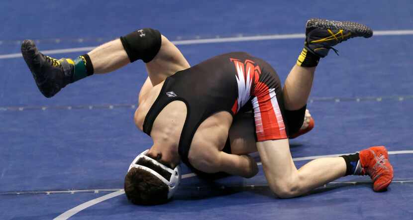 Argyle's Heath Roth attempts to pin El Paso Parkland's Clinton Wells in the 5A boys 120...