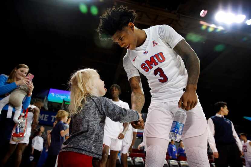 Southern Methodist Mustangs guard Kendric Davis (3) receives a handshake from 2 yr-old...