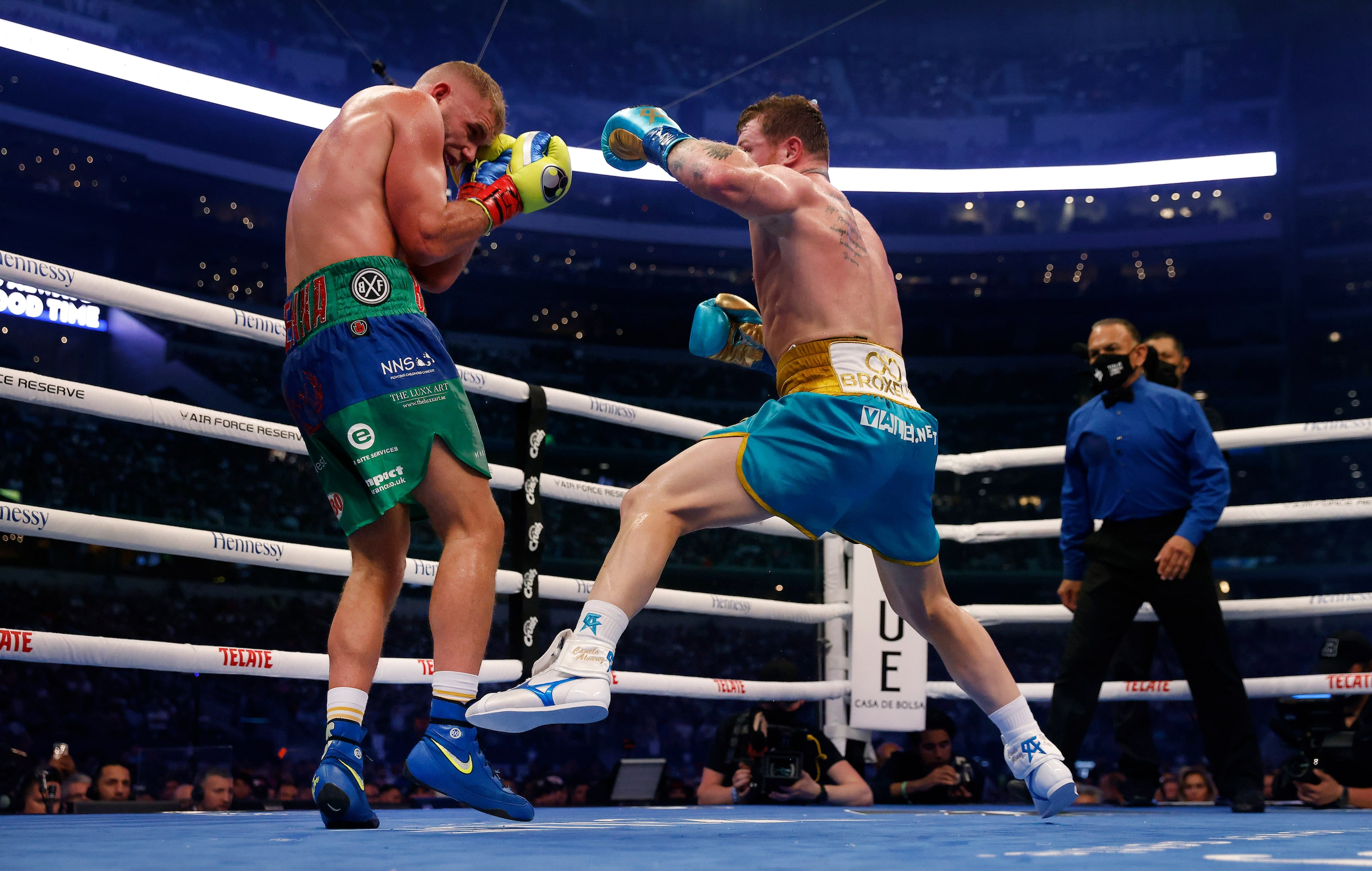 Boxer Canelo Alvarez (right) delivers a flurry of punches on Billy Joe Saunders during their...