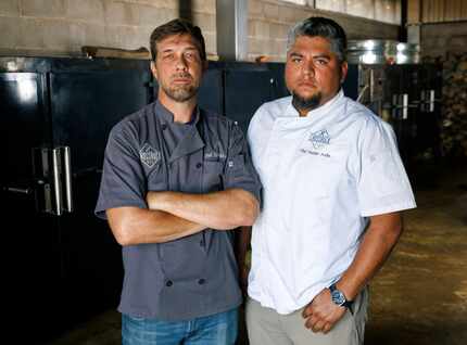 Crossbuck BBQ owner and chef Tim McLaughlin (left) stands with Damian Avila in the smoker...