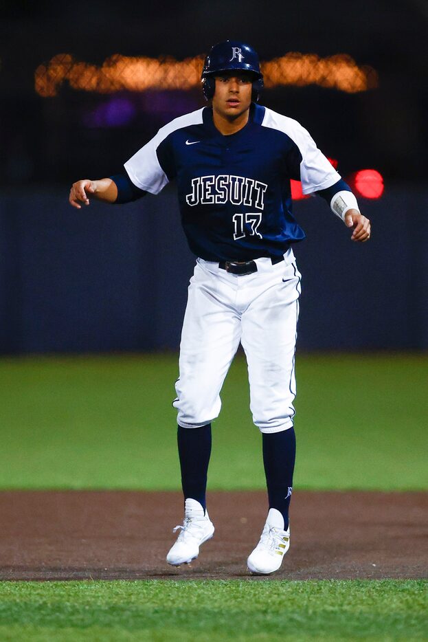 Jesuit senior Cash Riley leads off of first in the third inning during a high school...