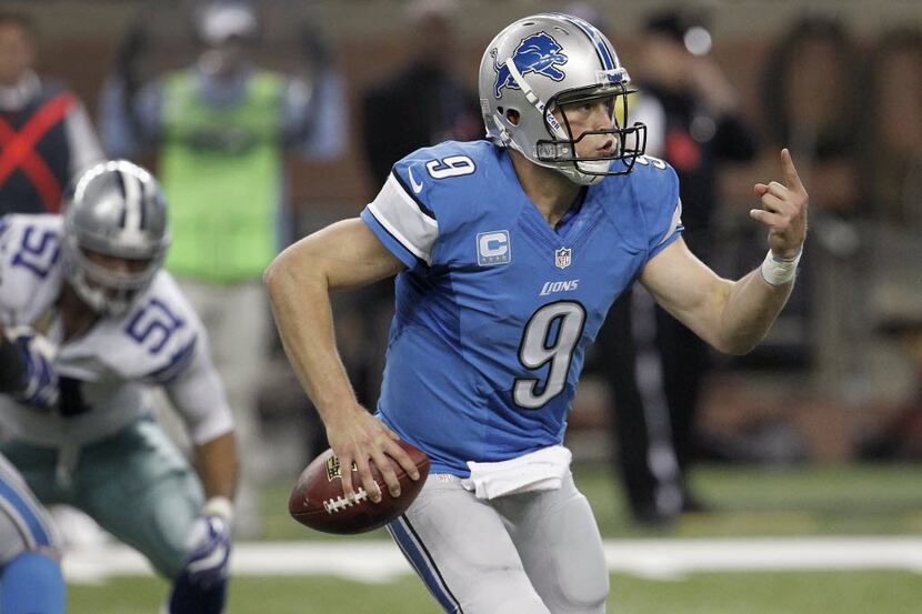 Detroit Lions quarterback Matthew Stafford (9) rolls out against the Dallas Cowboys in the...