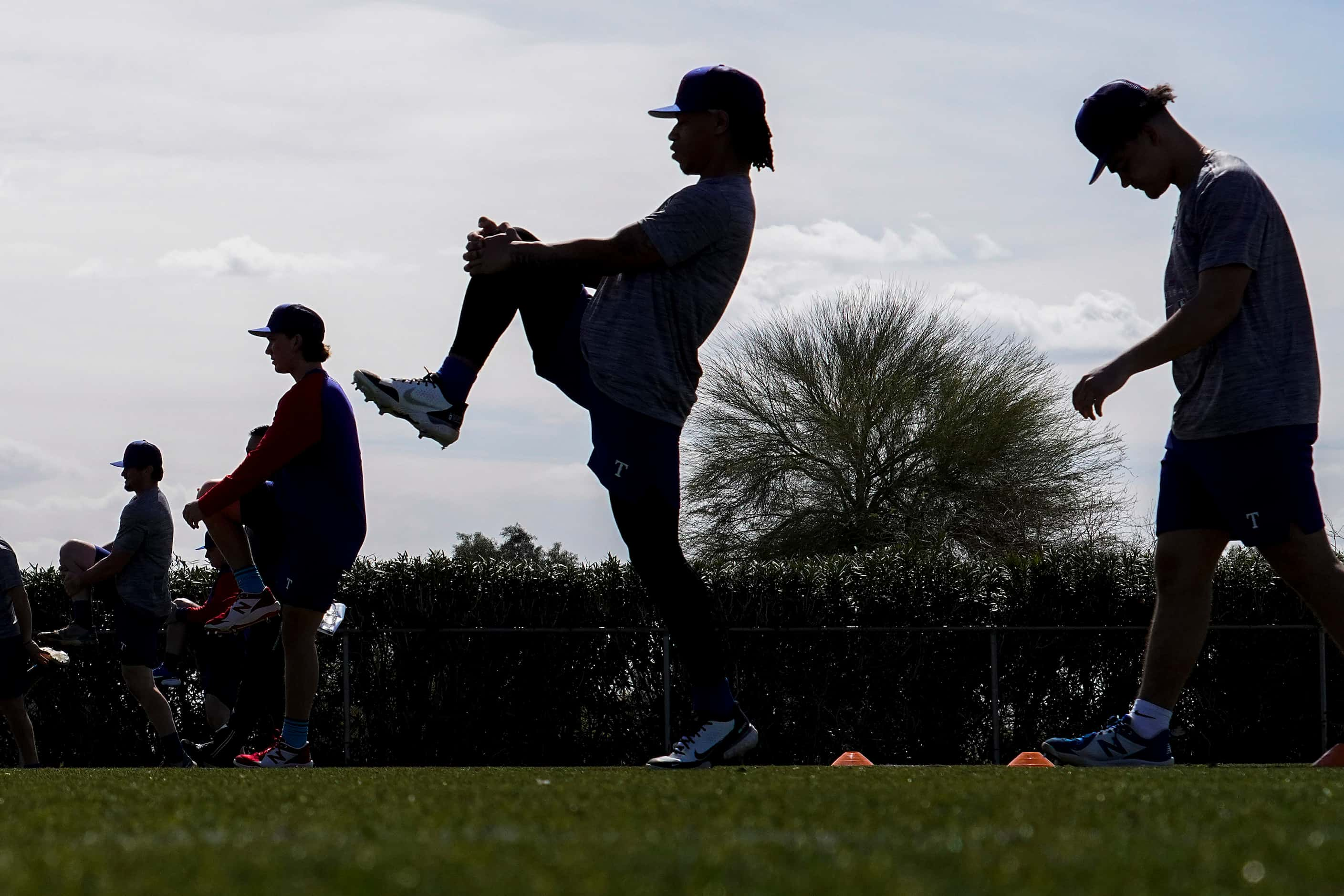 Players stretch on a conditioning field during the Texas Rangers first minor league spring...