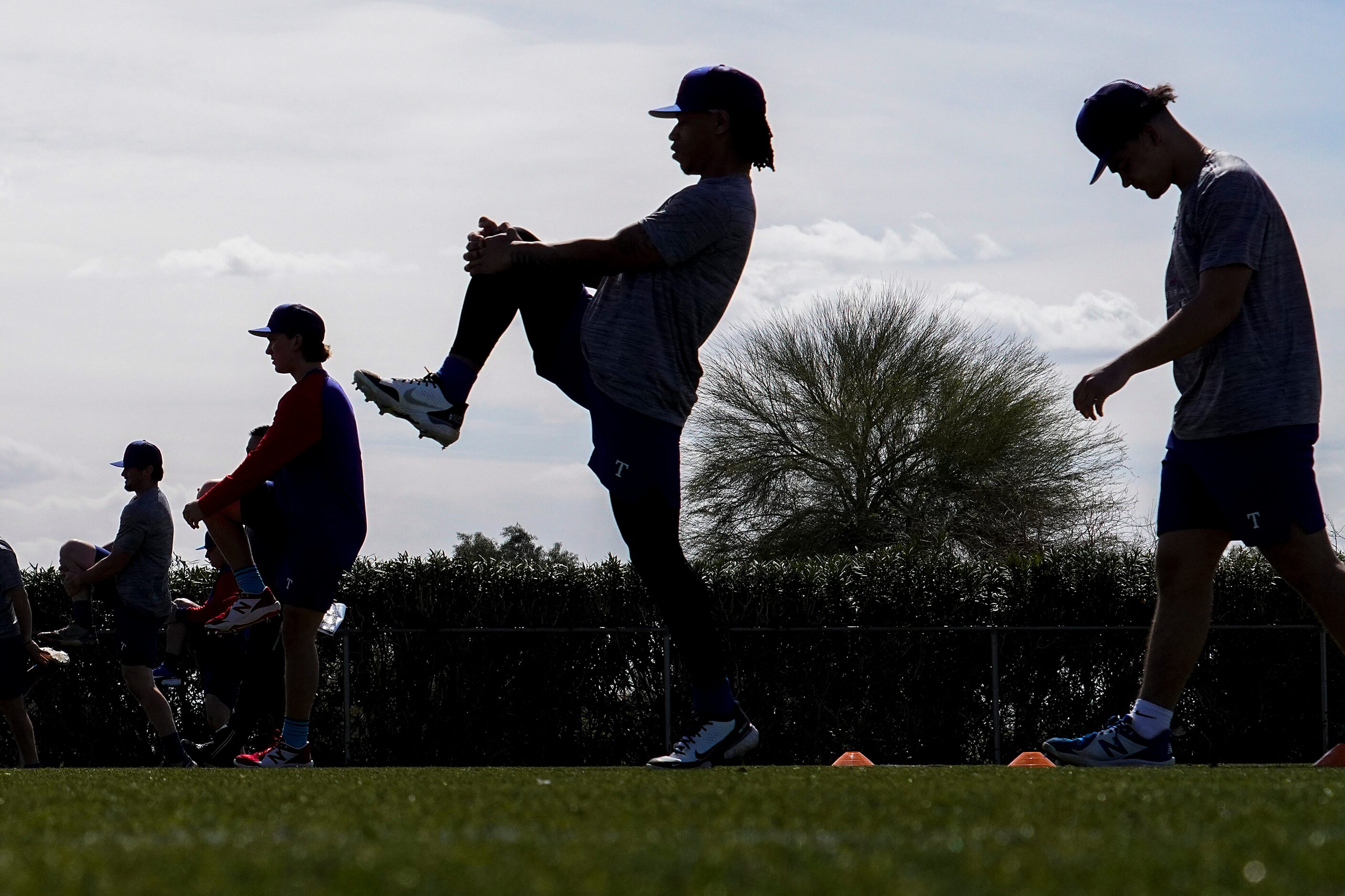 Players stretch on a conditioning field during the Texas Rangers first minor league spring...