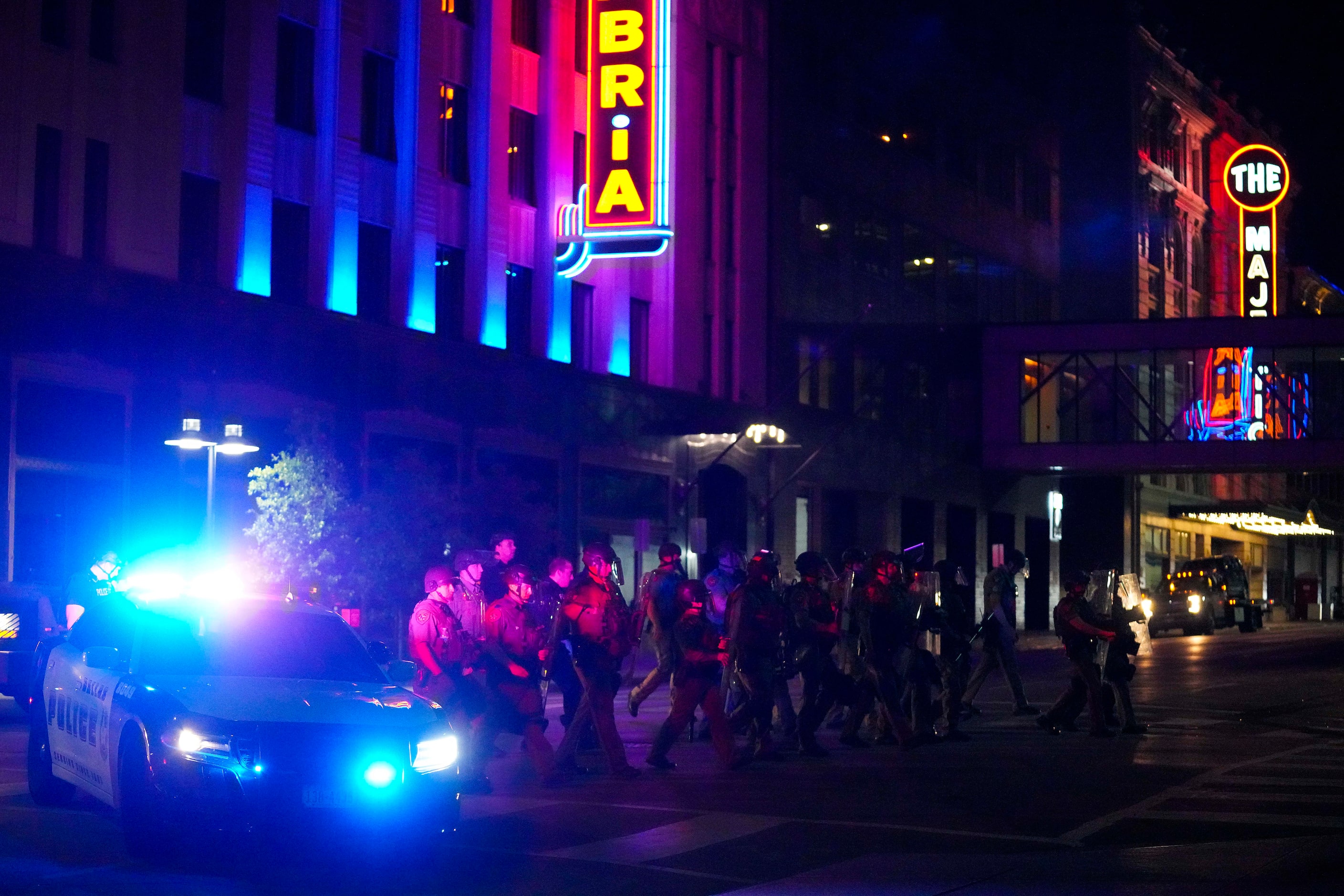 Dallas police and Texas Department of Public Safety troopers cross Elm Street at  St. Paul...