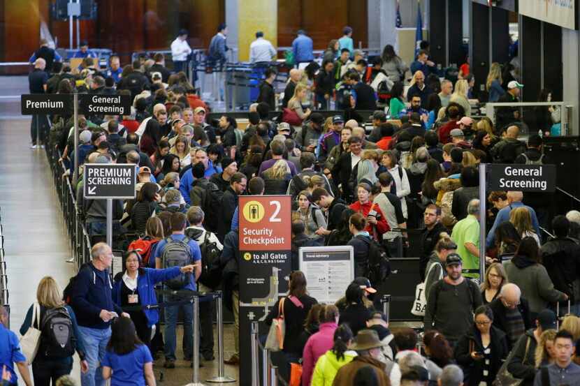
Travelers wait in line for security screening at Seattle-Tacoma International Airport in...