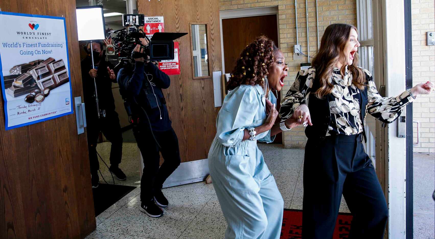 Patricia Byrd, left, and Drew Barrymore reacts as they open the entrance door to meet the...