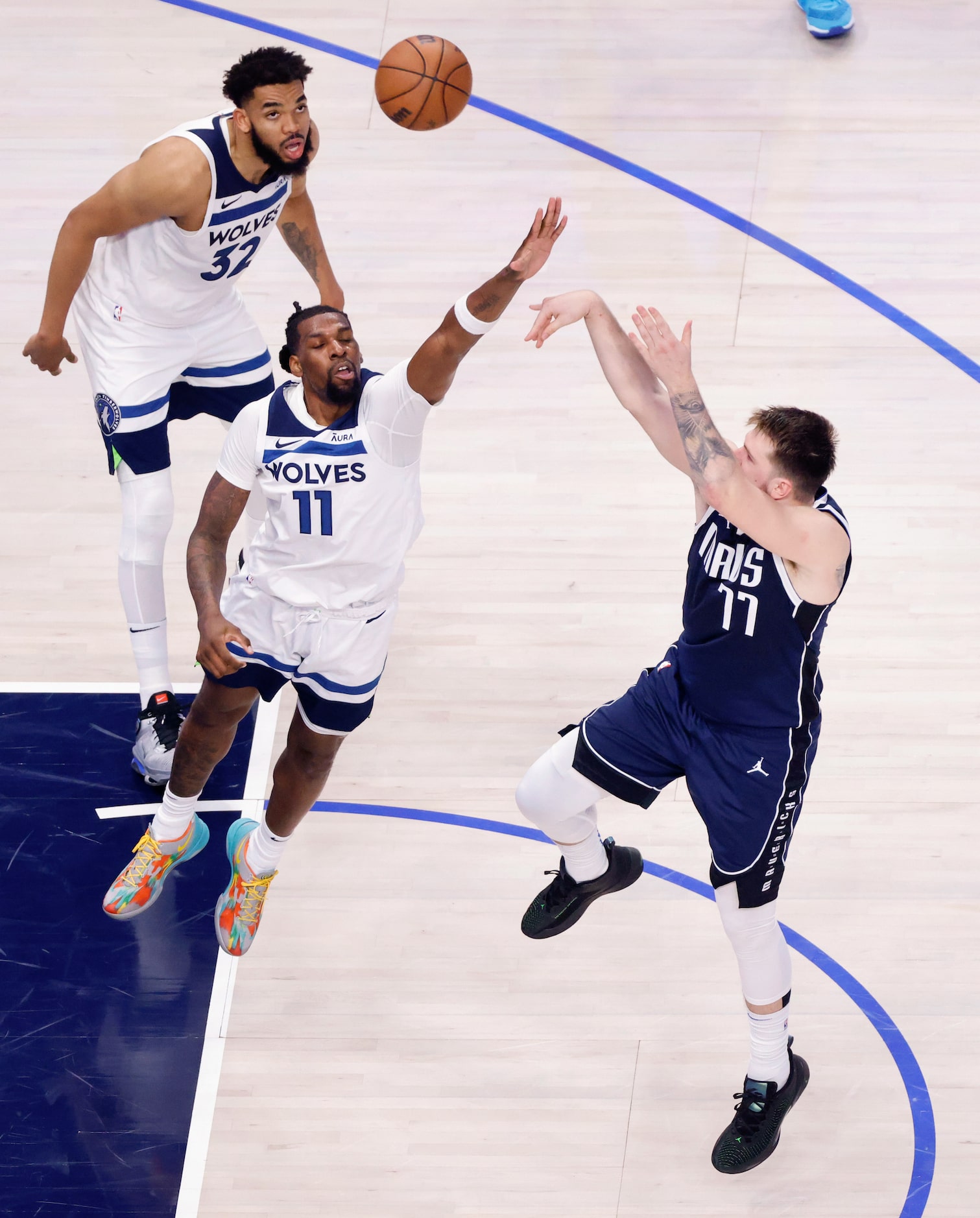 Dallas Mavericks guard Luka Doncic (77) sinks a fourth quarter shot over Minnesota...