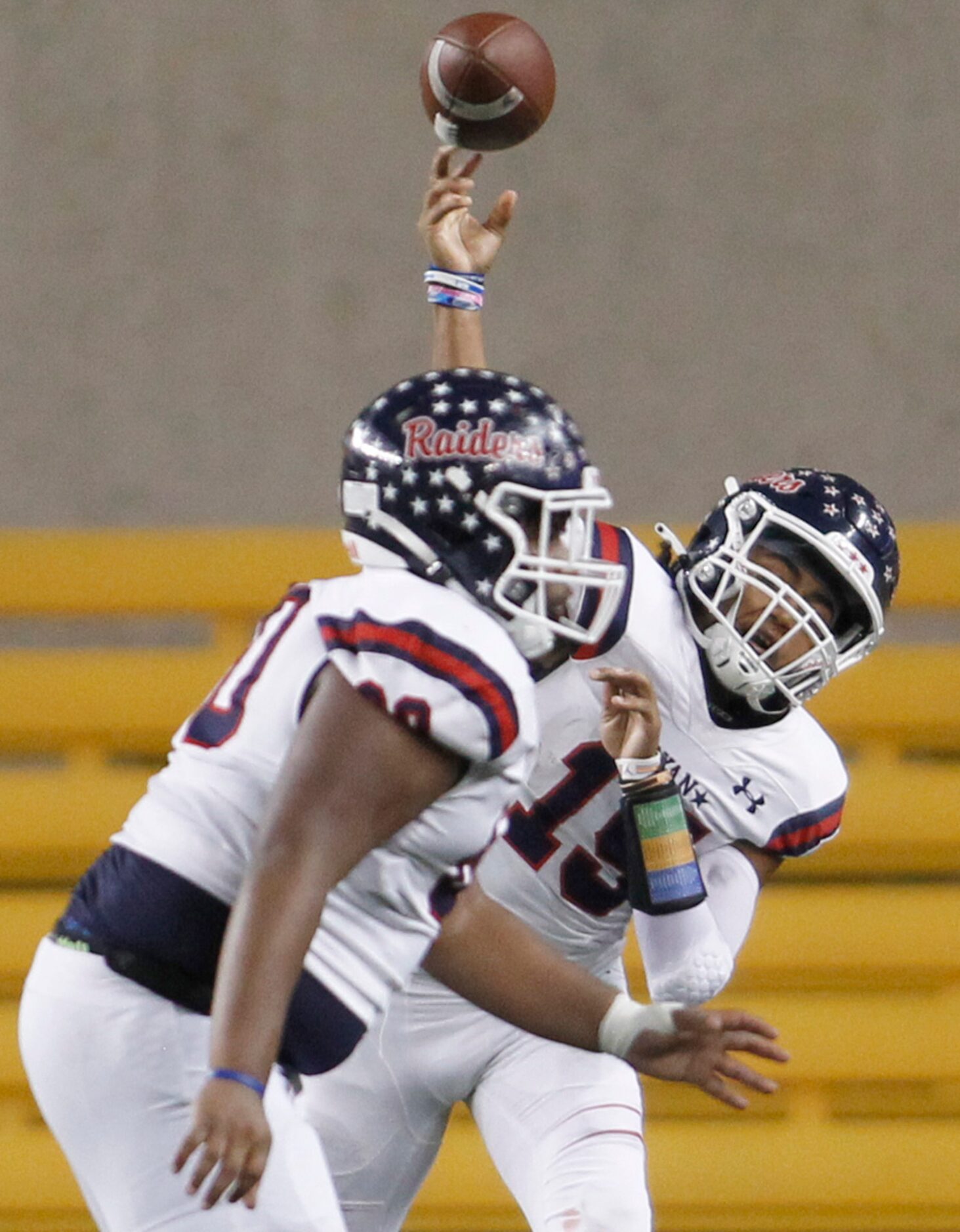 Denton Ryan quarterback Khalon Davis (15) launches a long pass behind the protection of...