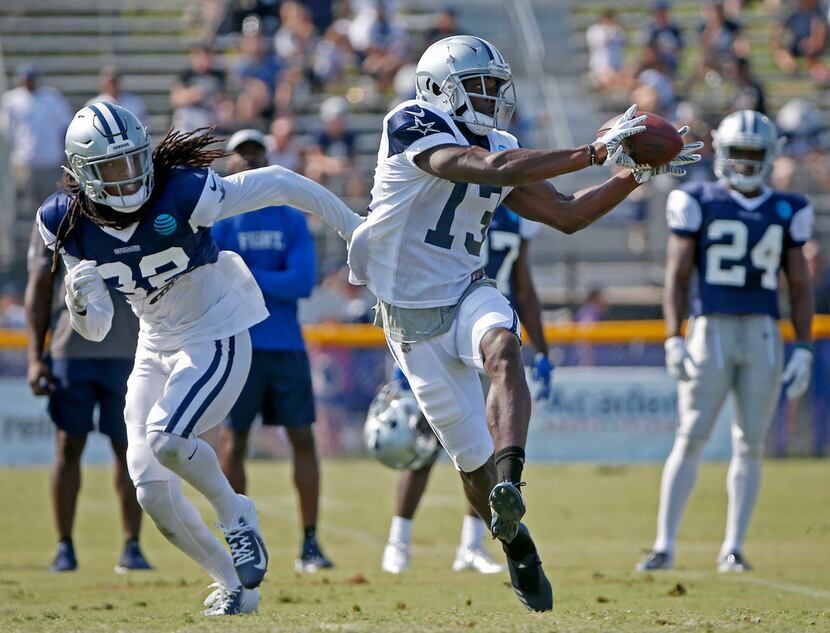 Dallas Cowboys wide receiver Michael Gallup, right, tries to catch a pass in front of...