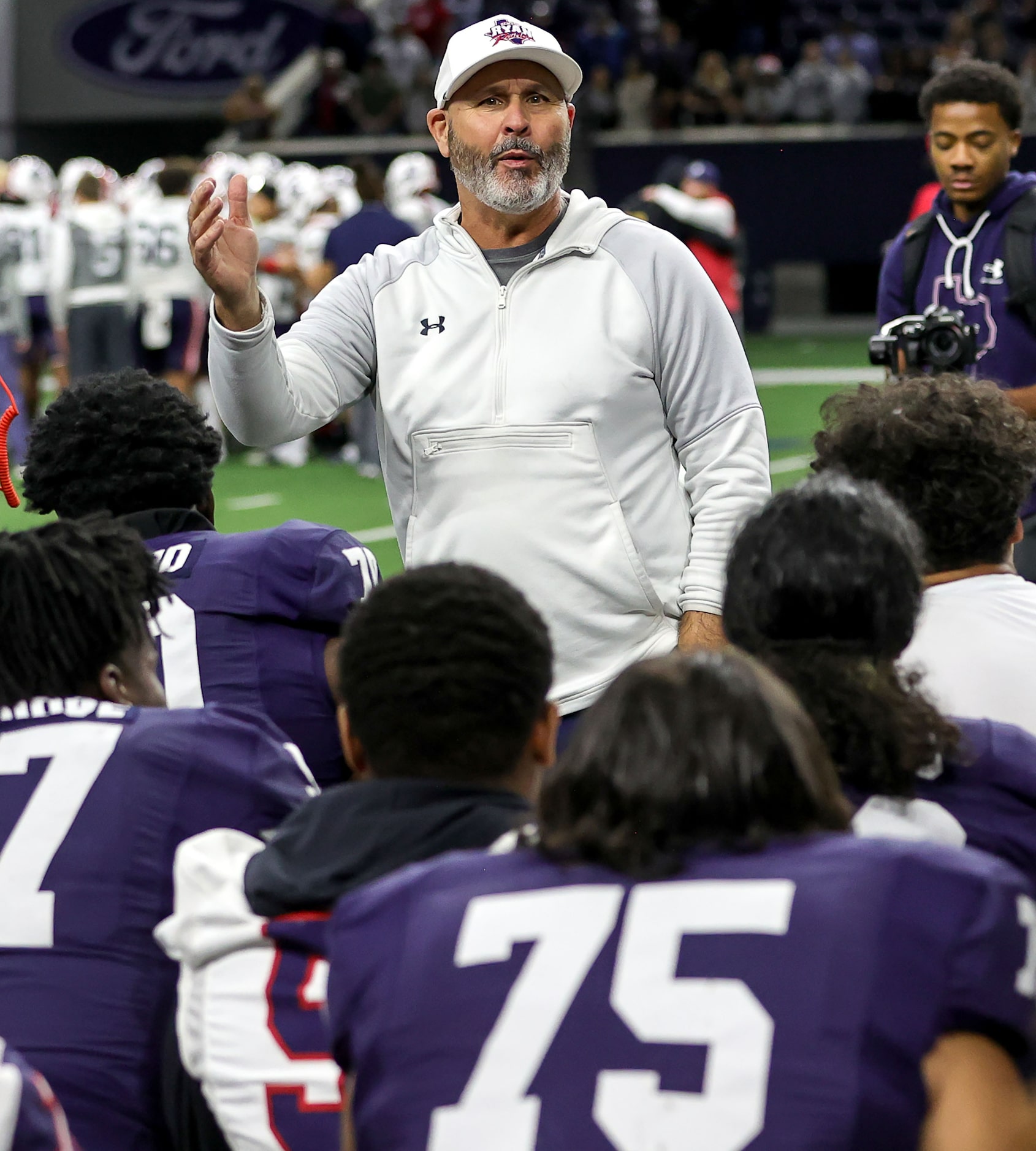 Denton Ryan head coach Dave Henigan talks to his team after defeating Richland, 48-35 in a...