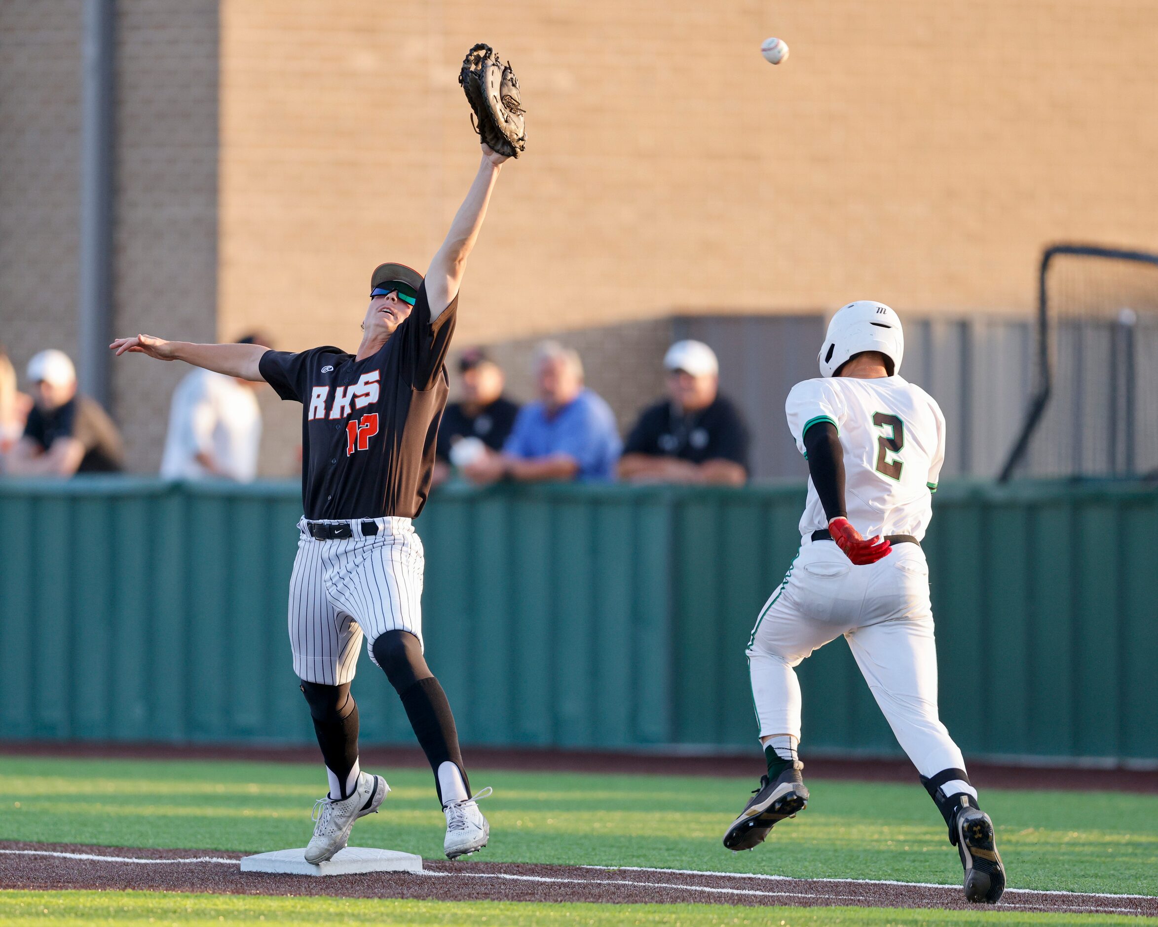 Rockwall first baseman Hunter Holt (17) reaches for an overthrown ball as Waxahachie pitcher...