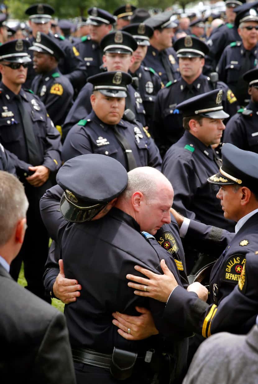 Dallas police officer comfort one another following the police Honor Guard Ceremony for...