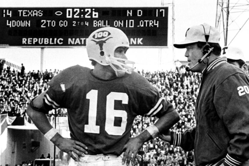 University of Texas quarterback James Street talks to coach Darrell Royal during the 1970...