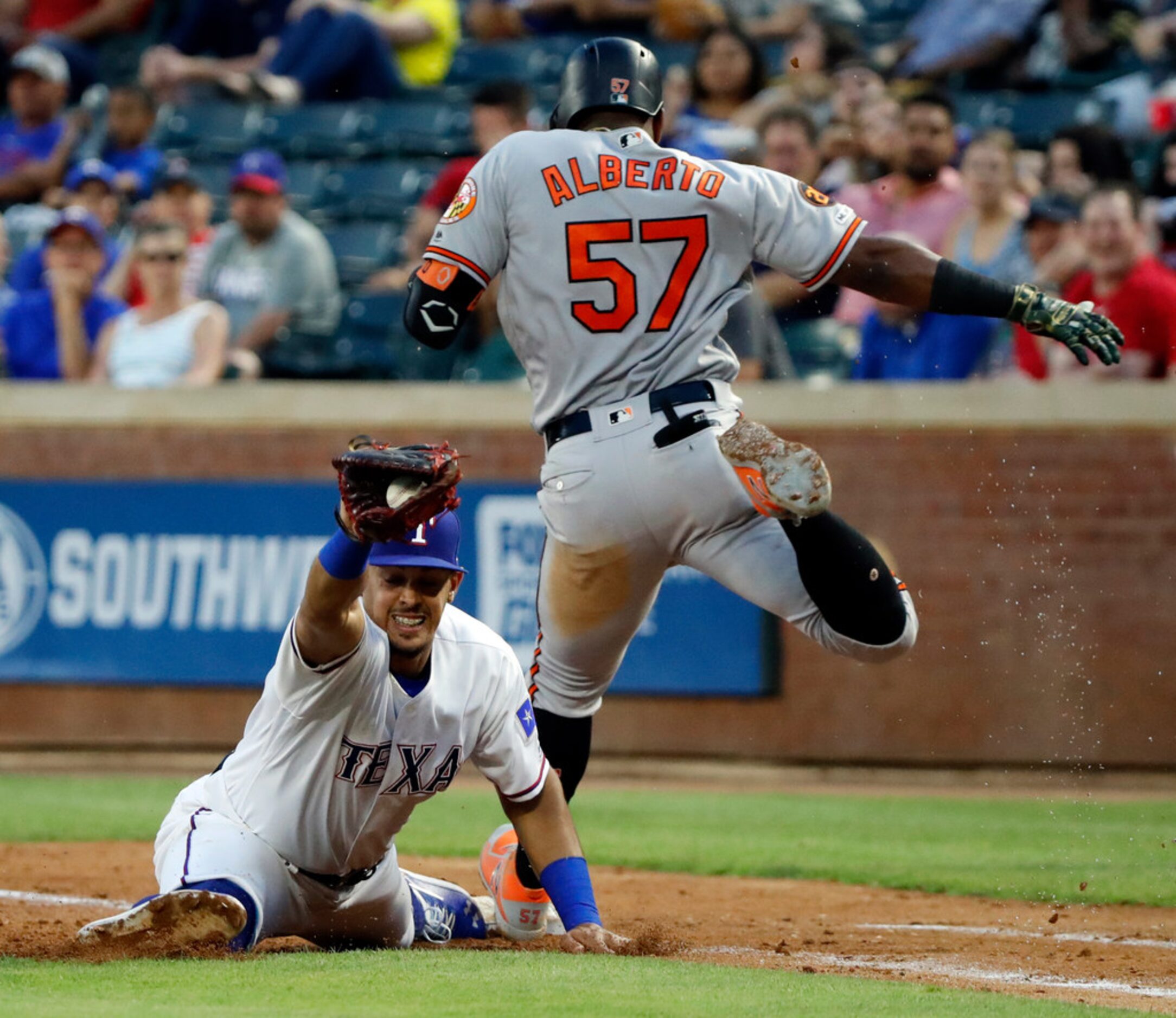 Texas Rangers first baseman Ronald Guzman reaches out for the throw to the bag as Baltimore...