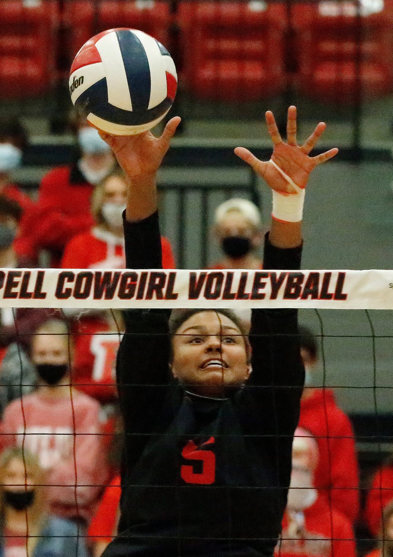 Lovejoy High School outside hitter Cecily Bramschrieber (5) tips a hit coming over the net...