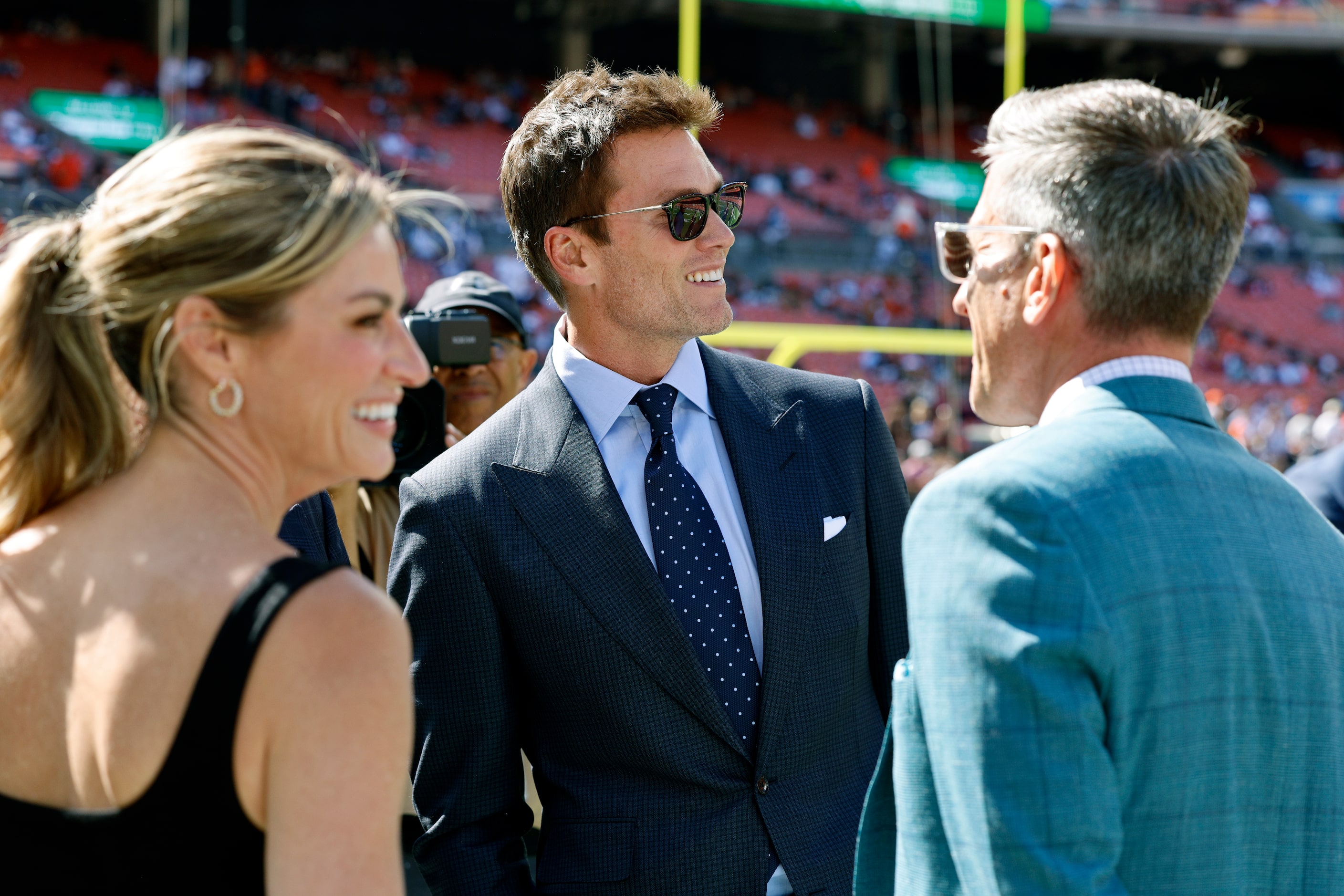 Former NFL player and Fox analyst Tom Brady talks on the field with Erin Andrews (left) and...