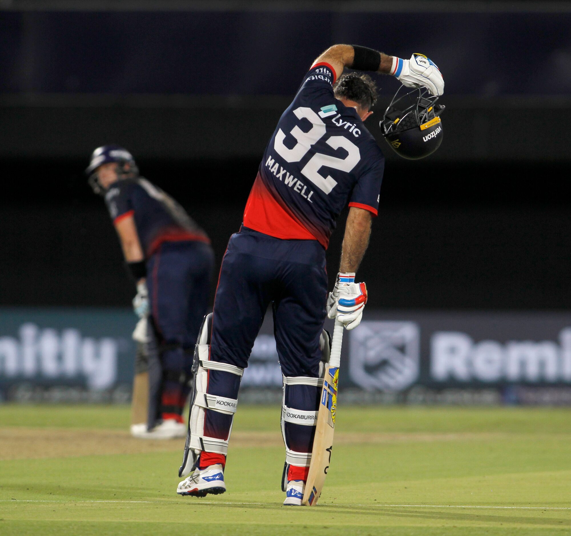 Washington Freedom's Glenn Maxwell (32) wipes away perspiration as a teammate prepares to...