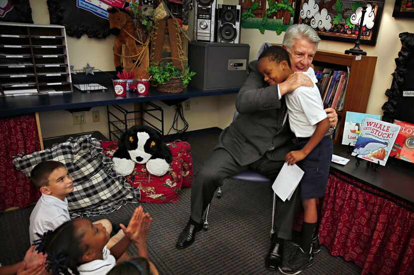 Pastor Jack Graham hugs Matthew Jordan after the 7-year-old handed him a hand-drawn...