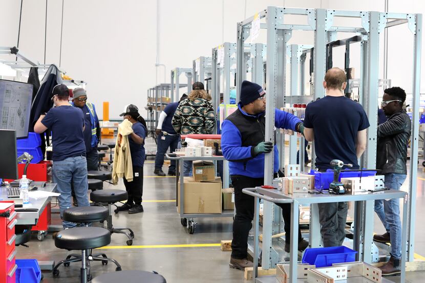 Siemens employees assemble some of the products to be made at the company's new Fort Worth...
