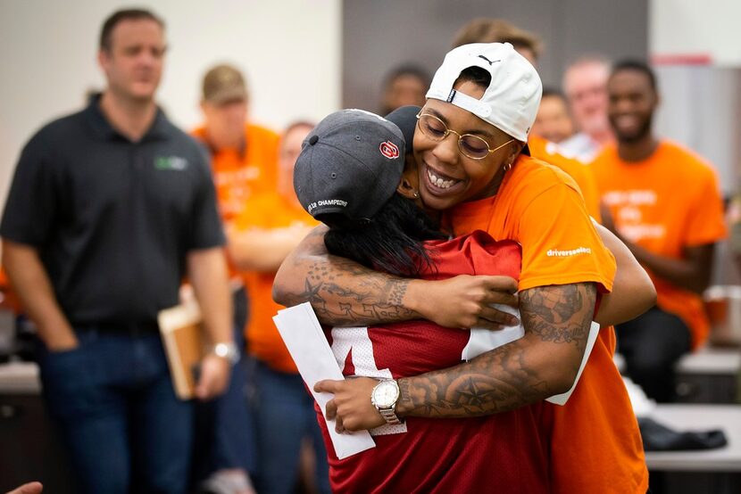 CiCi Hall (facing) hugs D.C. Cole after nominating her for a Care award during the monthly...