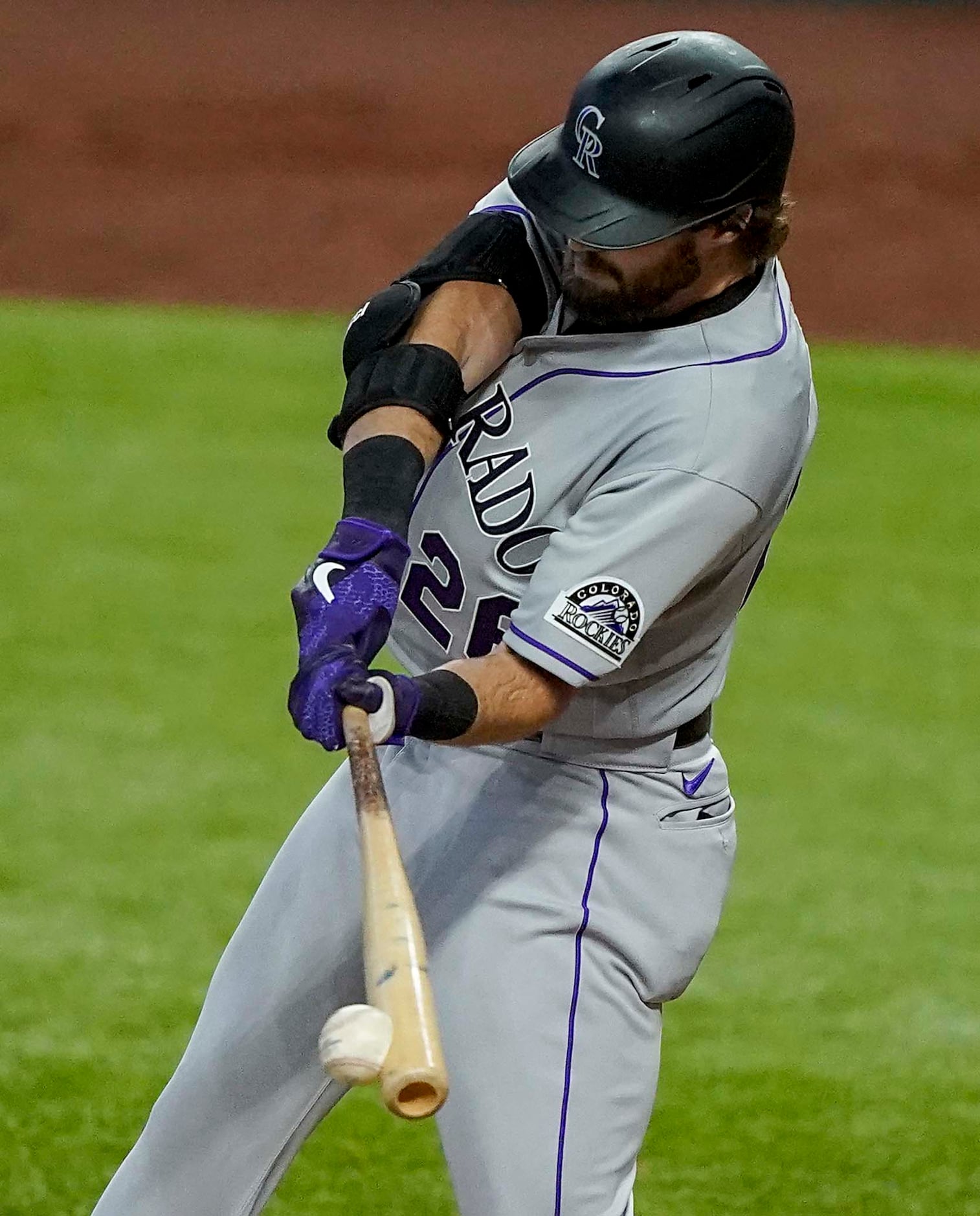 Colorado Rockies center fielder David Dahl drives in a run with a single in the seventh...