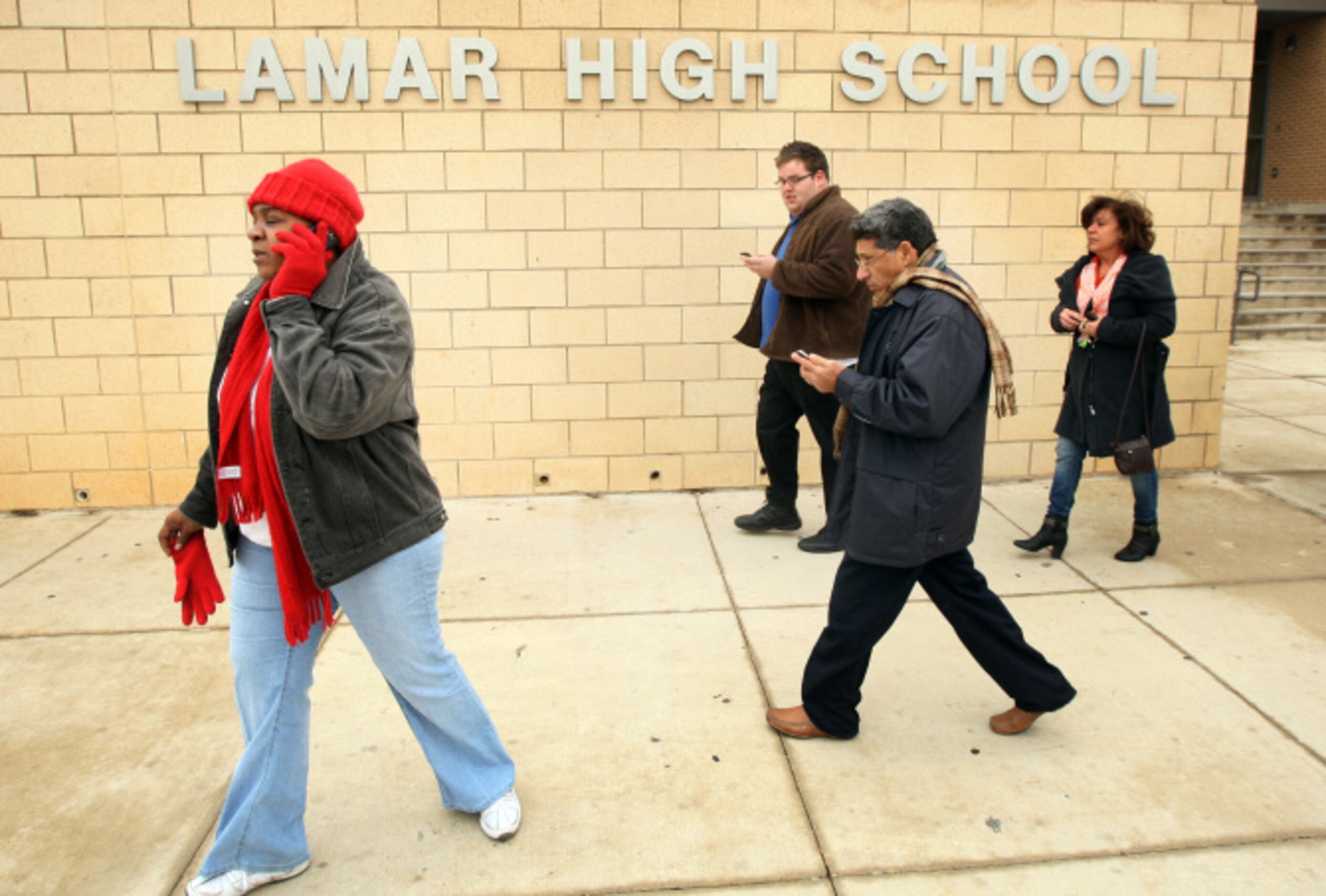 Parents rush to pick up their students after a lockdown at Arlington Lamar High School due...